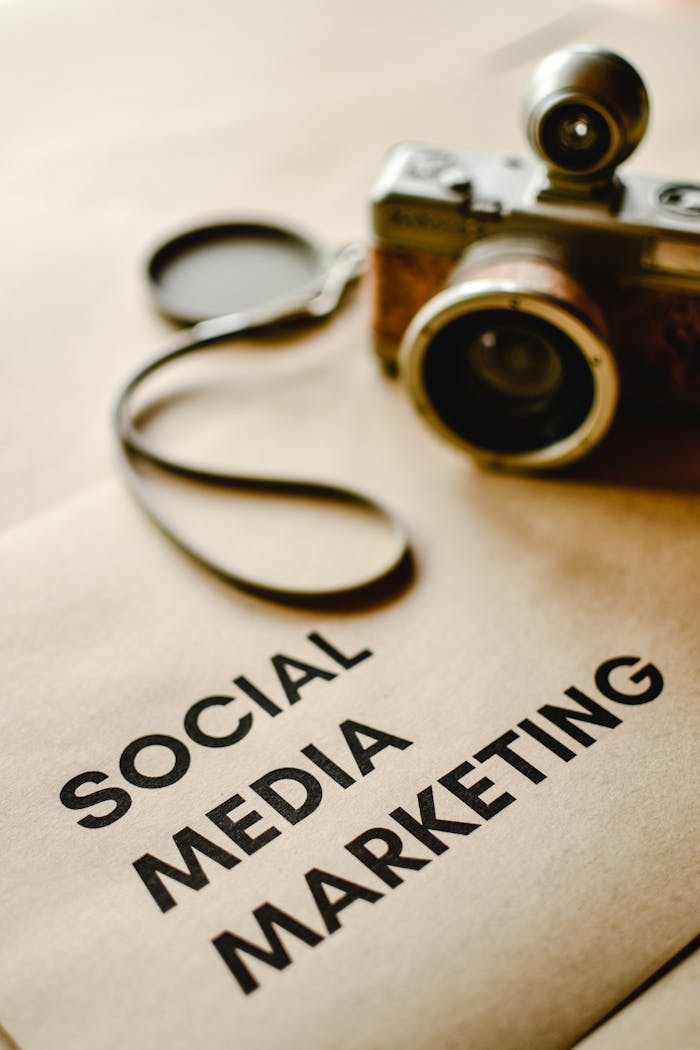 services-img Close-up of a vintage camera on brown paper labeled with 'Social Media Marketing'.