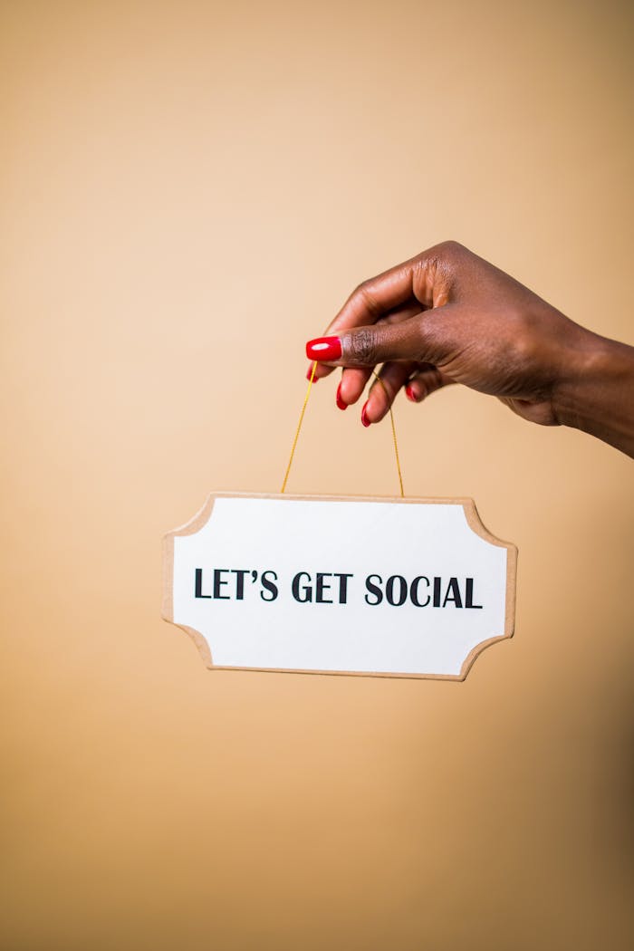 services-01 A hand holding a "Let's Get Social" sign, ideal for marketing and social media themes.
